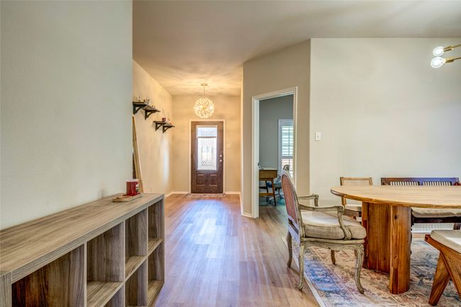 Foyer entrance with a chandelier, baseboards, and wood finished floors | Image 10
