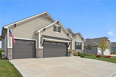 View of front of property with a front yard and a garage | Image 2