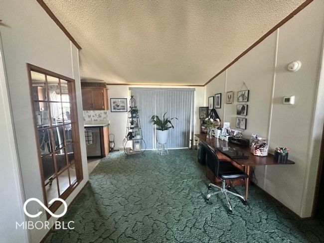 office featuring vaulted ceiling, carpet flooring, and a textured ceiling | Image 6