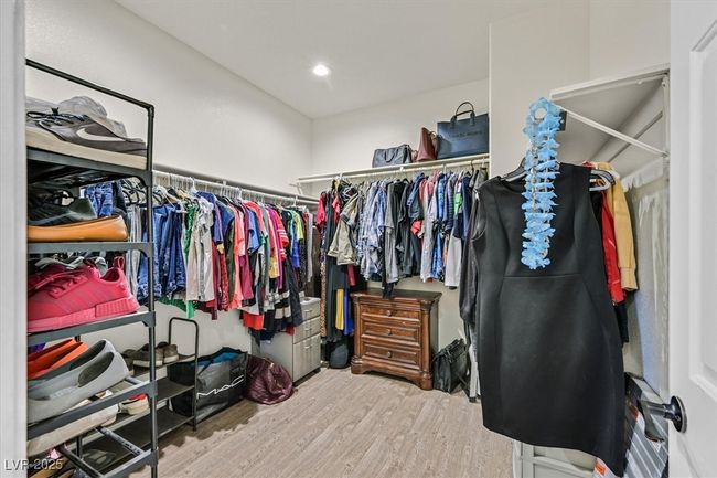 Spacious closet with wood finished floors | Image 19