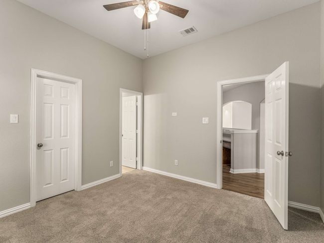 Unfurnished bedroom featuring visible vents, arched walkways, baseboards, and carpet flooring | Image 33