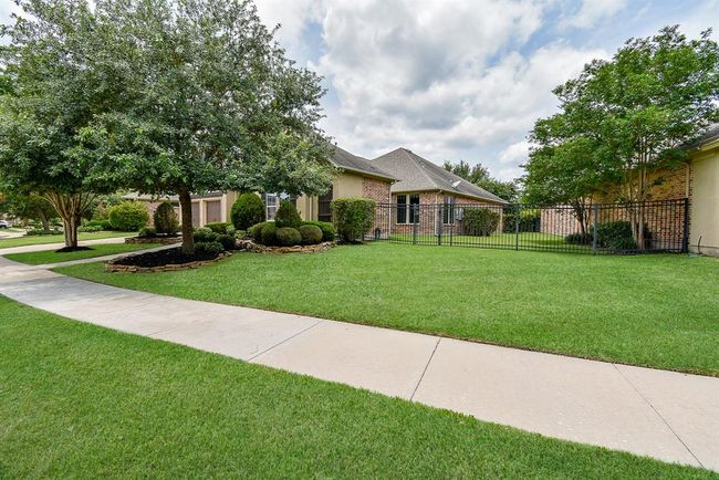 The front yard is spacious and well-maintained! | Image 48