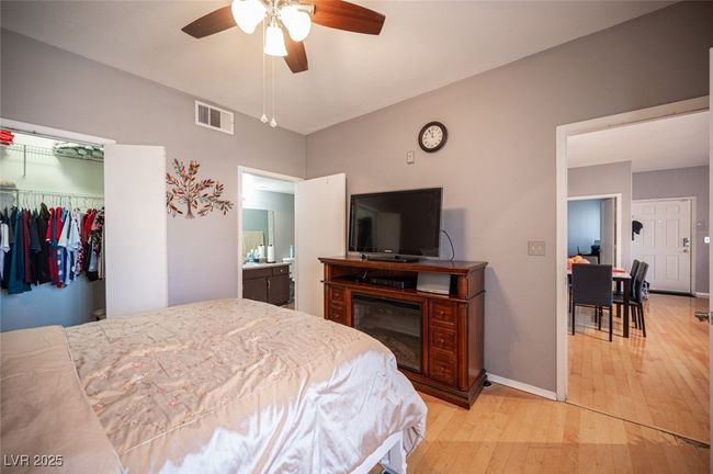 Bedroom featuring visible vents, a closet, baseboards, a ceiling fan, and light wood-style flooring | Image 19