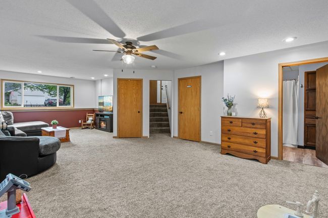 This family room is large enough to have multiple spaces or one large space for gatherings! There is plenty of storage underneath the stairs. | Image 16