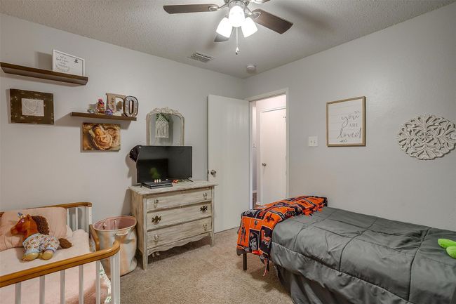 Bedroom with light colored carpet and ceiling fan | Image 21