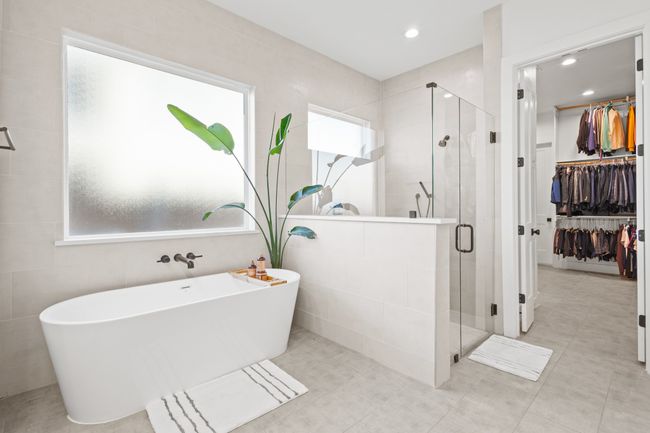 Bathroom featuring a stall shower, a freestanding bath, a spacious closet, recessed lighting, and tile patterned flooring | Image 20