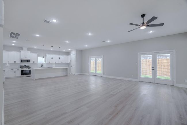 Spacious open-concept family room with soaring ceilings and natural light | Image 6