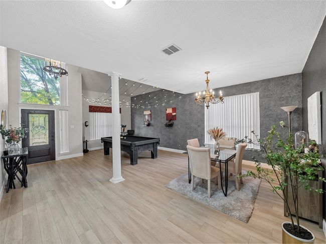 Dining room featuring visible vents, an accent wall, pool table, baseboards, and a notable chandelier | Image 10