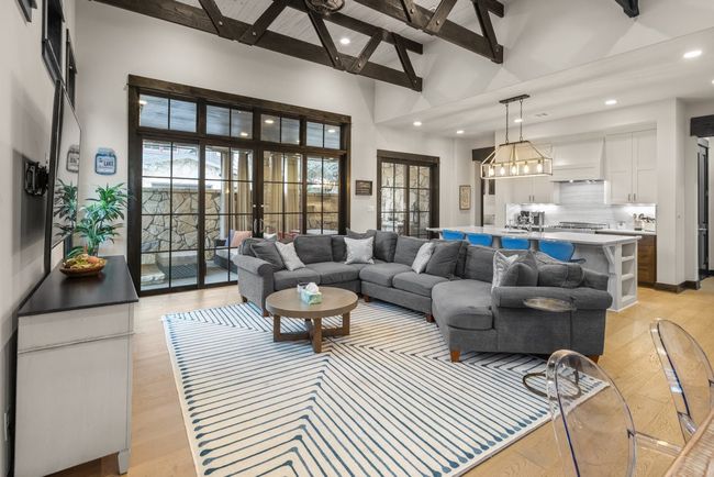 LARGE OPEN LIVING WITH SLIDING WOOD DOORS TO COVERED ENTERTAINMENT AREA | Image 7