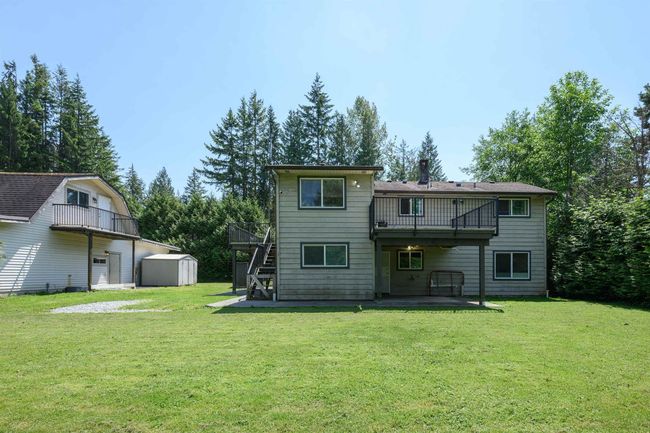 Back of house featuring a patio, stairs, a lawn, and a balcony | Image 8