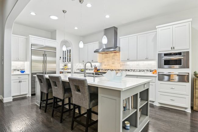 White cabinetry and built-in refrigerator | Image 11