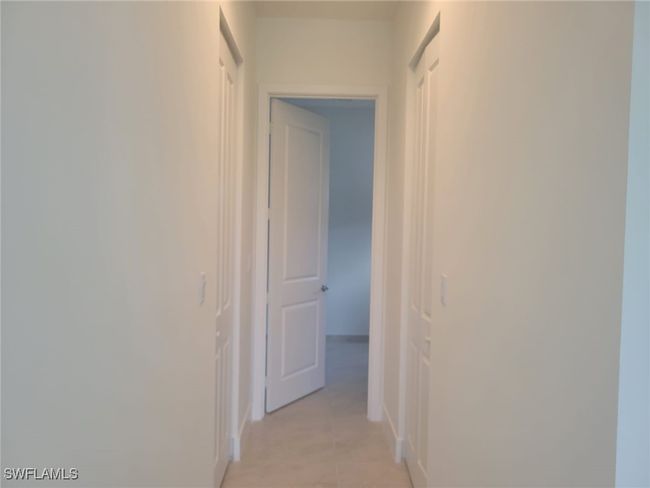 Corridor with light tile patterned floors | Image 12