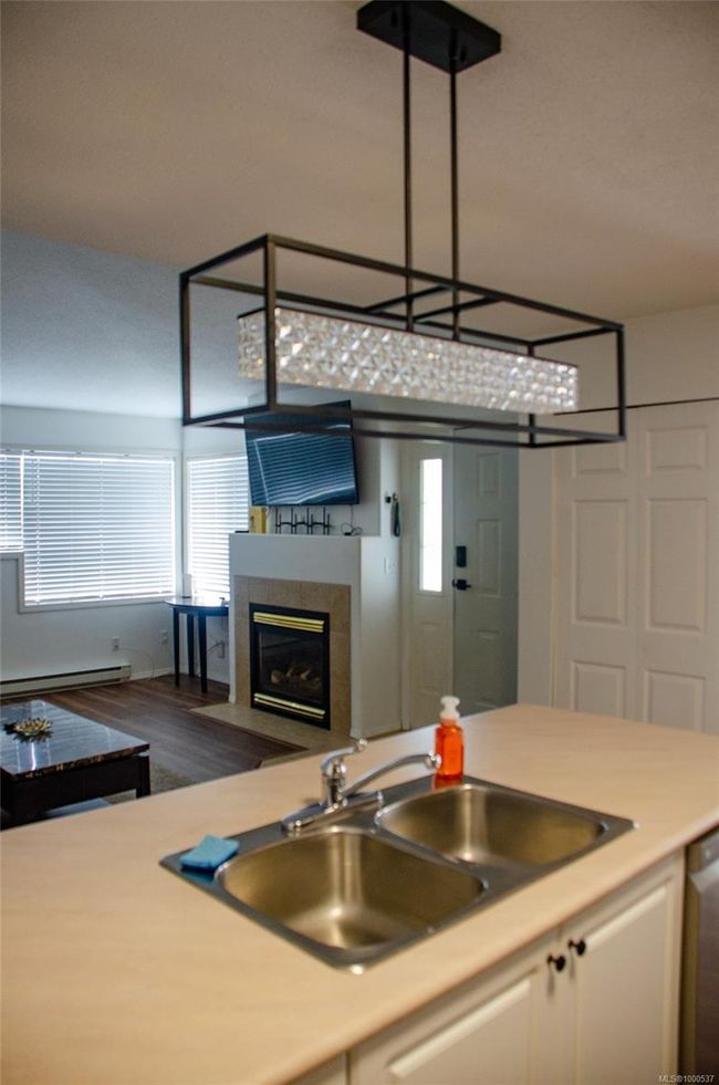 Living area with vaulted ceiling, wood finished floors, and baseboards | Image 19