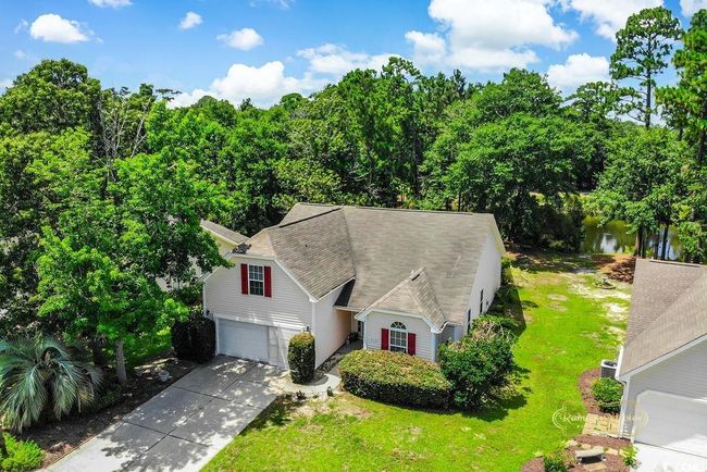 View of front facade featuring driveway, a front yard, a garage, and roof with shingles | Image 4