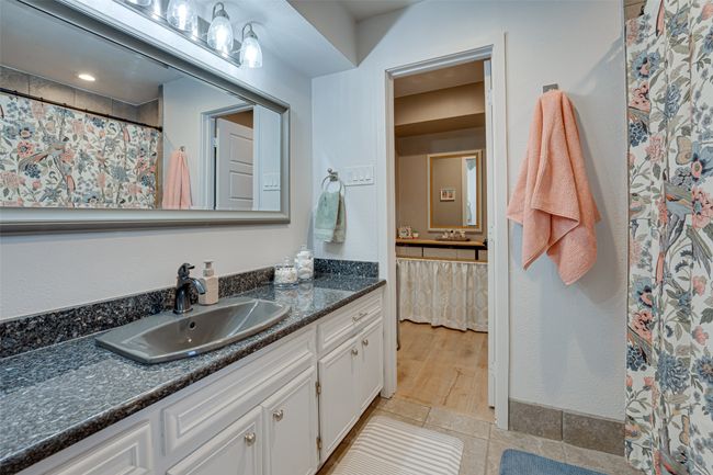 Bathroom featuring vanity, tile patterned flooring, and a shower with shower curtain | Image 19