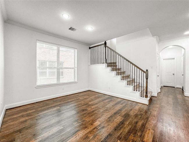 Cozy breakfast nook bathed in natural light, perfectly nestled within a spacious open floorplan—ideal for morning coffee or casual meals. | Image 7