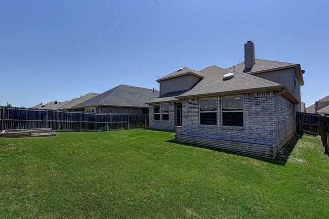 Back of property featuring brick siding and a chimney | Image 22