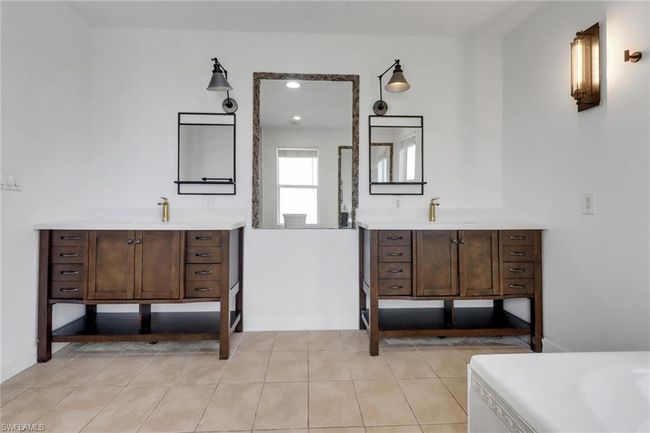 View of the living and dining area! Huge space with recess lighting, vaulted ceilings, travertine tile, and tons of natural lighting! | Image 15