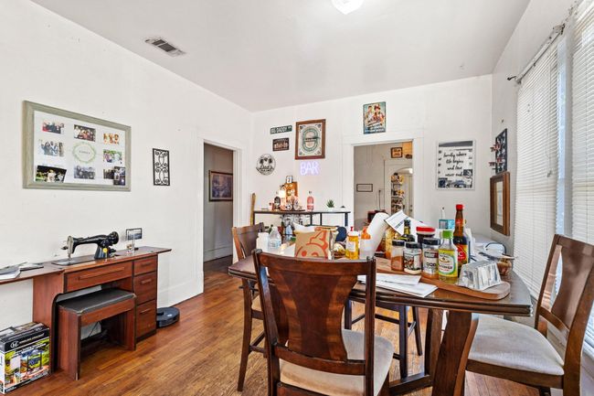 Dining room with wood finished floors and a desk | Image 6