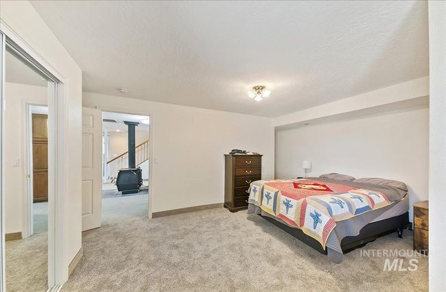 Bedroom with light carpet and a textured ceiling | Image 31