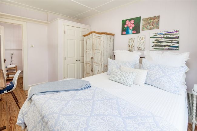 Bedroom with wood finished floors and a closet | Image 38