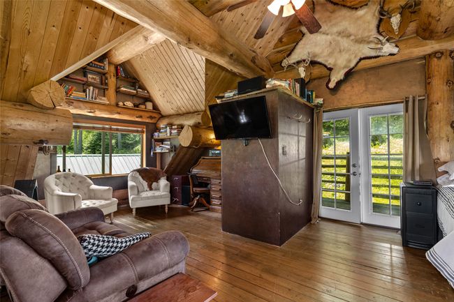 Living area with hardwood / wood-style flooring, wood ceiling, and ceiling fan | Image 22