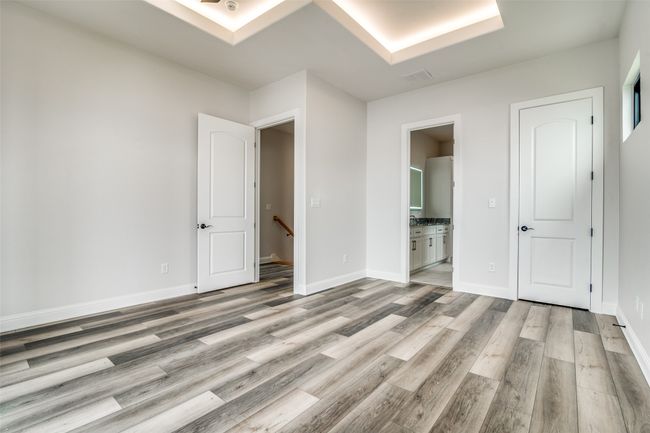 Unfurnished bedroom with ensuite bathroom and wood-type flooring | Image 17