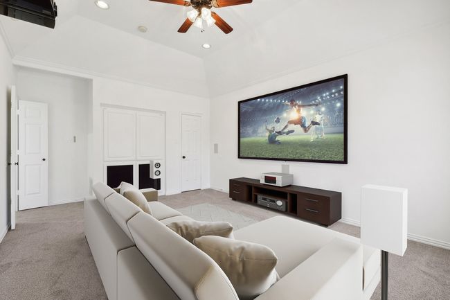 Carpeted living room featuring a ceiling fan, baseboards, and recessed lighting | Image 19