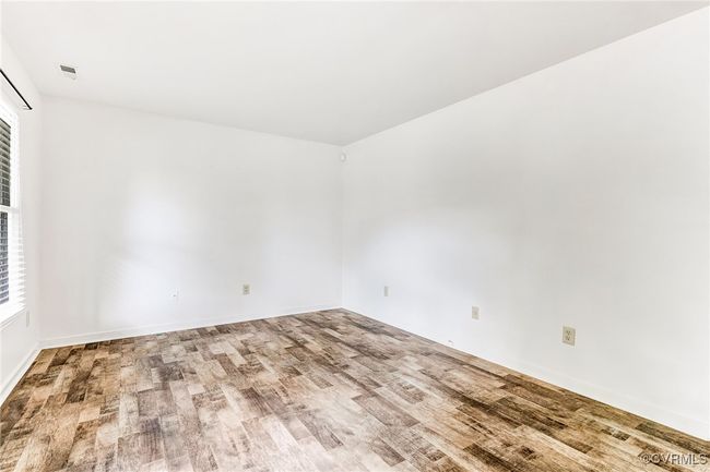 Unfurnished room featuring wood finished floors and baseboards | Image 11
