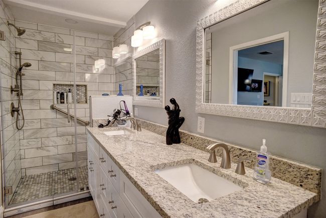 Full bathroom featuring a shower stall and double vanity | Image 18