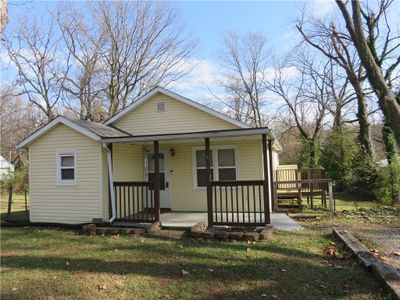 Bungalow with a front yard and a porch | Image 1