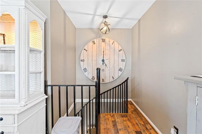 Spiral staircase to the finished lower level | Image 25