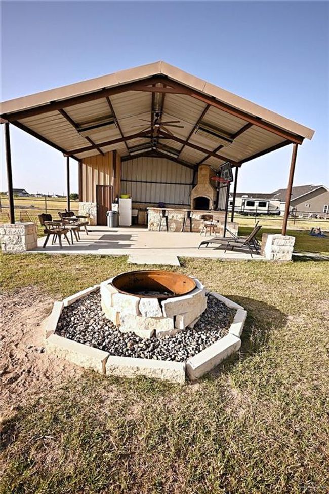 View of yard with a patio and a fire pit | Image 5