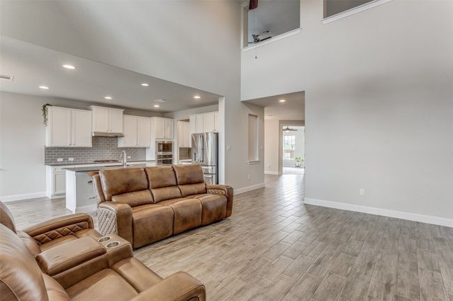 Living room with a ceiling fan, light wood finished floors, and recessed lighting | Image 4