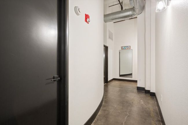 Hall featuring concrete flooring and baseboards | Image 18