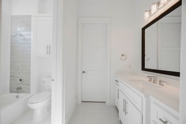 Full bathroom featuring vanity, shower combination, and light tile patterned floors | Image 30