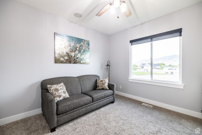 Sitting room with carpet floors, ceiling fan, and a mountain view | Image 62