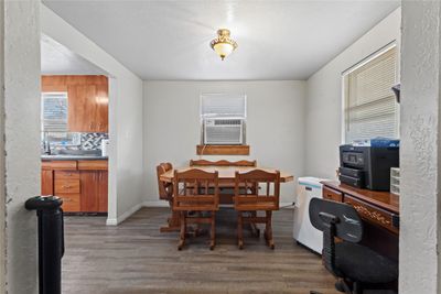 Dining space featuring cooling unit, sink, dark wood-type flooring, and a wealth of natural light | Image 3