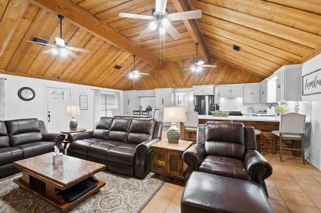 The open floor plan really accentuates the incredible beauty of the custom cedar ceiling. | Image 12