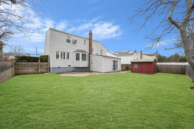 Rear view featuring a Patio area, a Storage Shed, and a Yard | Image 34