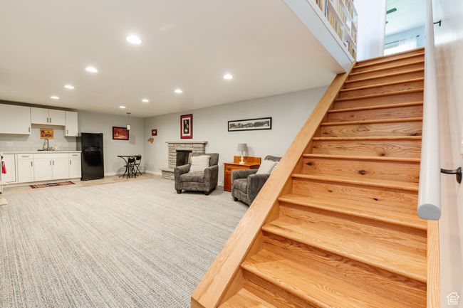 Stairs with a fireplace, baseboards, and recessed lighting | Image 22