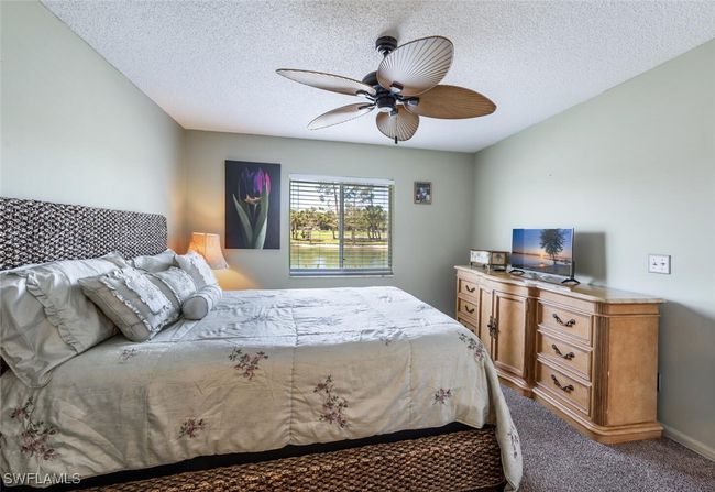 Bedroom featuring ceiling fan, carpet, and a textured ceiling | Image 10