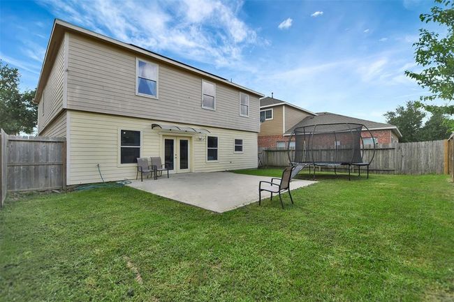 Spacious backyard featuring a large patio, perfect for outdoor entertaining and relaxation. | Image 43