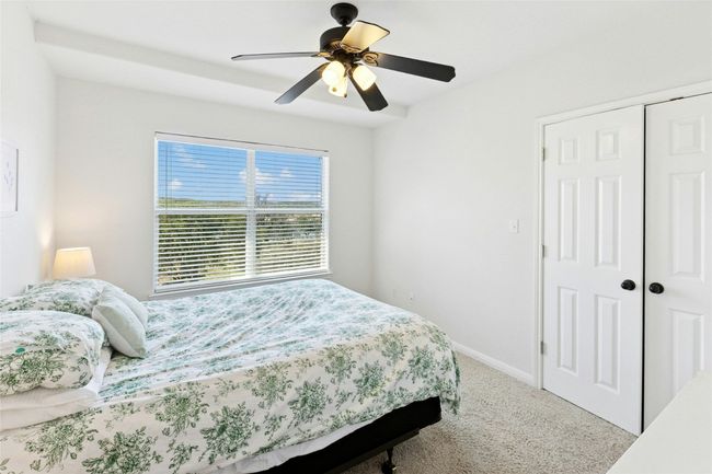 Carpeted bedroom with a closet and a ceiling fan | Image 23