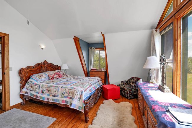 Bedroom with hardwood / wood-style floors and lofted ceiling | Image 22