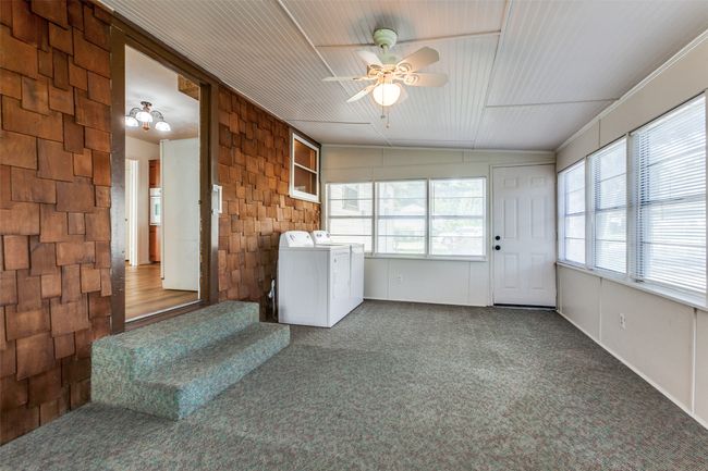 Unfurnished sunroom featuring washing machine and dryer | Image 17