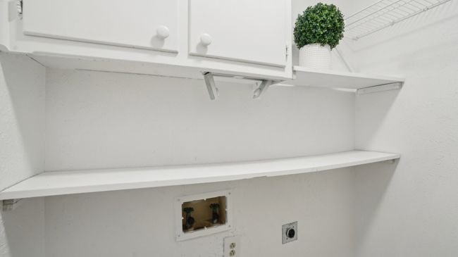 Laundry room with hookup for a washing machine, cabinet space, and electric dryer hookup | Image 30