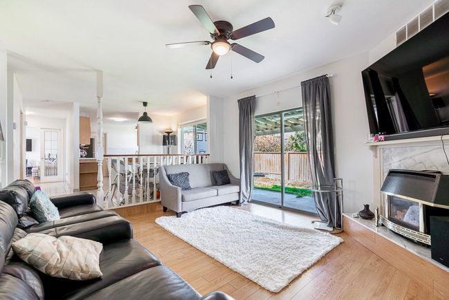 Living room featuring wood finished floors, visible vents, and ceiling fan | Image 7