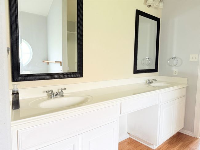 Bathroom with double vanity and wood finished floors | Image 9
