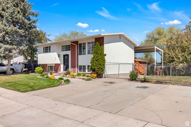 Raised ranch with brick siding, fence, and a front yard | Image 5